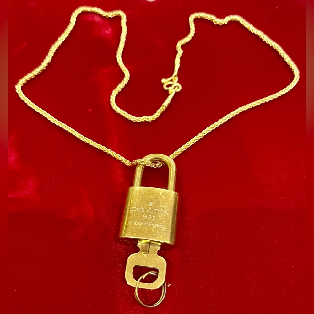 Louis Vuitton padlock 310 and unbranded gold necklace